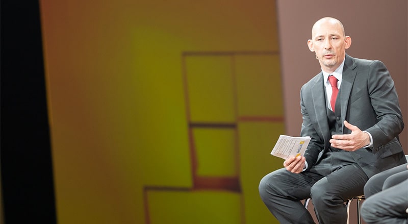 Bryan Daugherty talking in stage