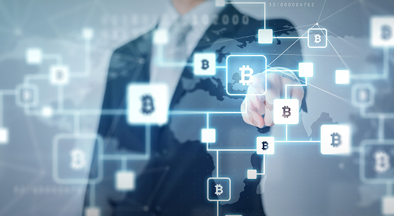 Man touching digital bitcoin nodes representing blockchain economy
